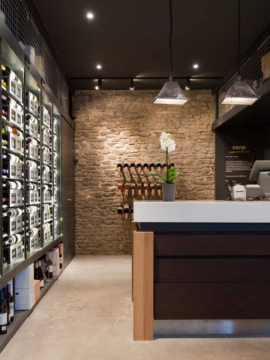 Oeno Wines shop interior in Cirencester, bespoke wine display with LED lighting and dark matt grey shelving by Millar Howard Workshop